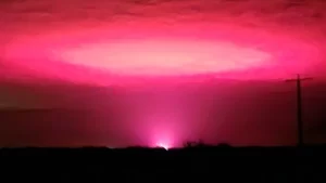 Cannabis farm behind eerie pink sky over Australian town