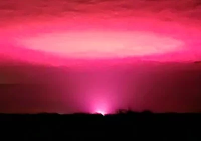 Cannabis farm behind eerie pink sky over Australian town