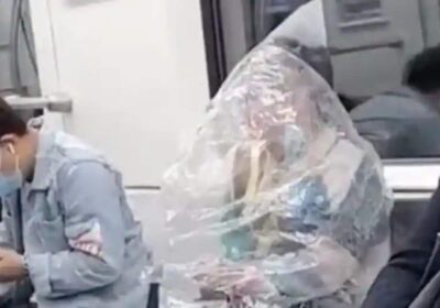 China: Woman eats banana on train covered in plastic bag .